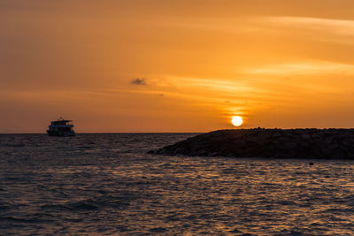 Scenic view of sea against orange sky