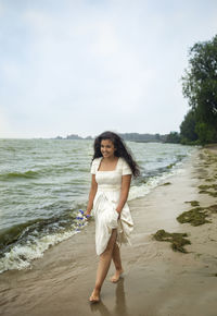 Full length portrait of man standing on beach