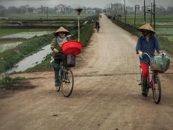 People riding bicycle on road