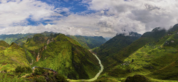 Panoramic view of green landscape against sky