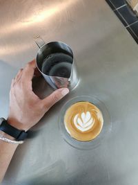 Hand holding coffee cup