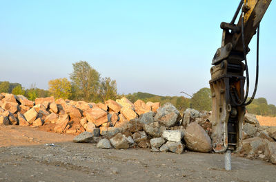 Stack of rocks on field against clear sky