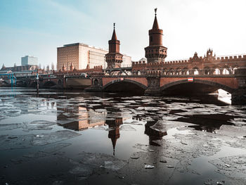 Arch bridge over river in city