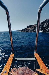 Sailboat on sea against clear sky