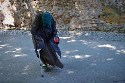 Homeless person walking on road