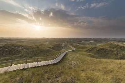 Scenic view of landscape against sky during sunset