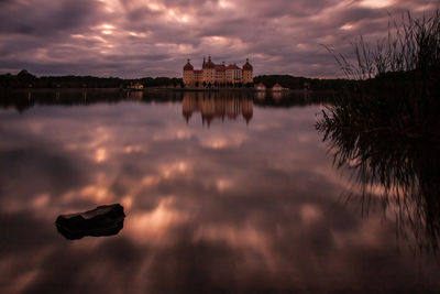 Reflection of clouds in lake at sunset