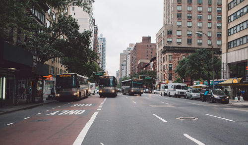 Cars on road along buildings