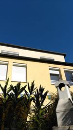 Low angle view of building against clear blue sky