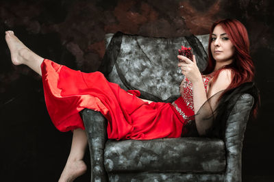Beautiful young woman sitting on seat