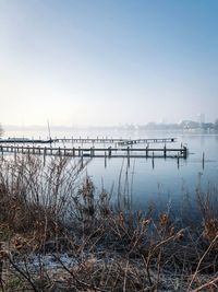 Scenic view of lake against clear sky during winter