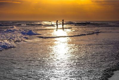 Scenic view of beach against sky during sunset