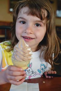 Portrait of cute girl holding ice cream