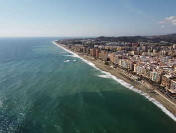 High angle view of sea and buildings against sky