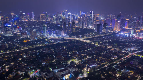 High angle view of illuminated city buildings at night