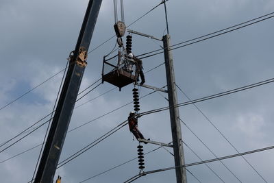 Low angle view of electricity pylon against sky