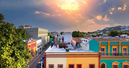 High angle view of buildings against sky at sunset