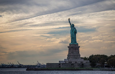 Statue of liberty against cloudy sky