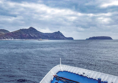 Ship approaching habour against sky