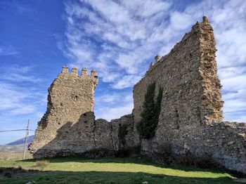 Low angle view of stone structure against sky