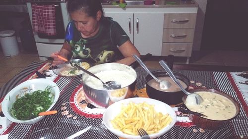 Close-up of man preparing food on table at home