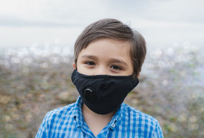 Close-up portrait of boy wearing mask