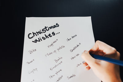 Cropped hand writing in book