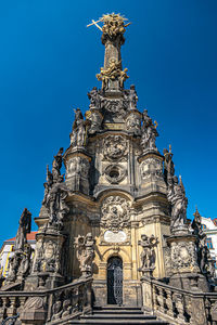 Low angle view of statue against blue sky