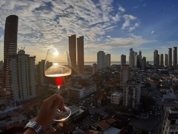 Aerial view of modern buildings against sky during sunset