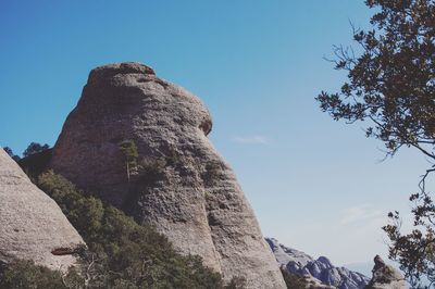 Low angle view of rock formation against sky