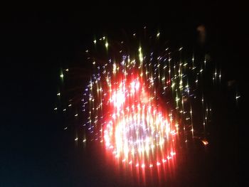 Low angle view of firework display at night