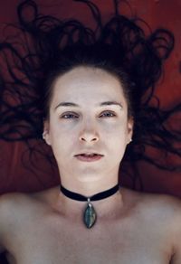 Portrait of a young woman laying on the floor with her hair wet 