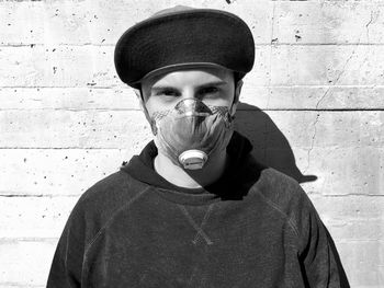 Portrait of man standing against wall