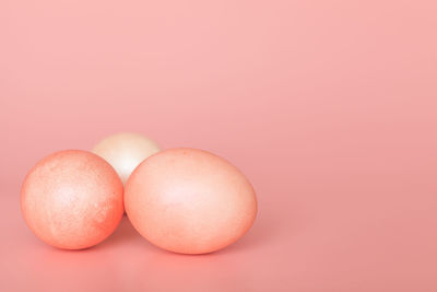 Close-up of apple against pink background