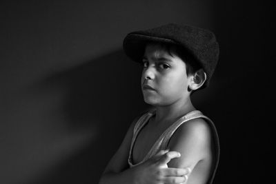 Portrait of boy against black background