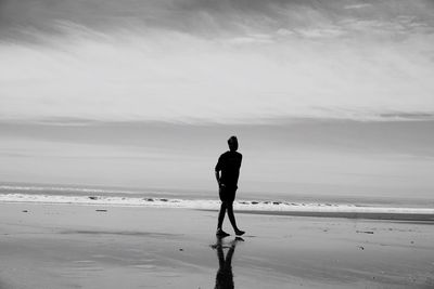 Full length of man on beach against sky