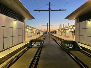 Railroad tracks amidst buildings against clear sky