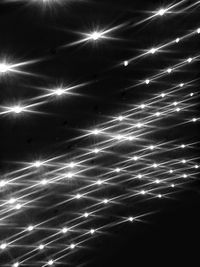 Low angle view of illuminated lights at night