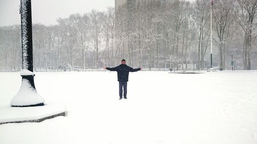 Person walking on snow covered landscape