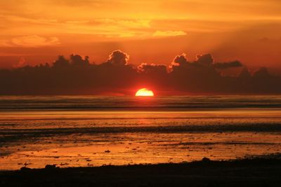 Scenic view of sea against orange sky