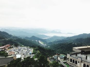 High angle view of houses and mountains against clear sky