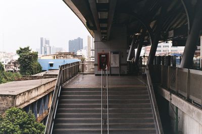 Railroad tracks amidst buildings in city