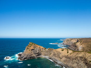 Scenic view of sea against clear blue sky