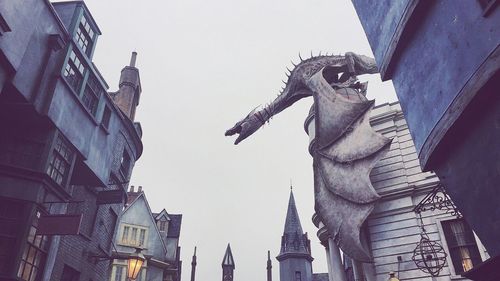 Low angle view of statue against sky in city