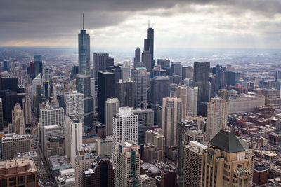 Aerial view of modern buildings in city against sky