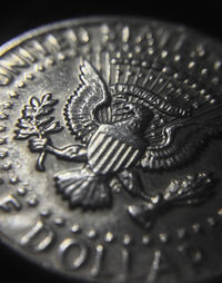 Close-up of coins on black background