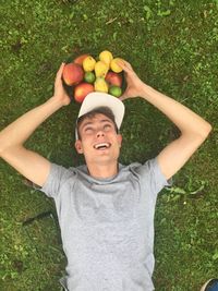 Portrait of happy boy playing on grassy field