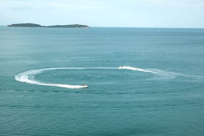 High angle view of people jet boating on sea
