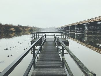 Pier over lake against sky