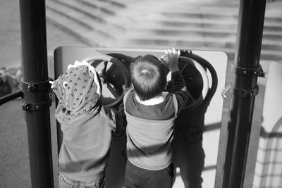 Rear view of people standing on floor